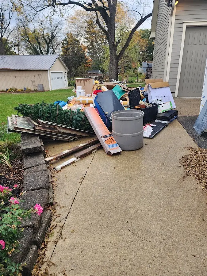 Dumpster being loaded with debris for 12 Yard Dumpster Rental in Edenton